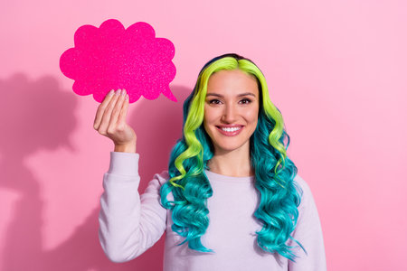 Portrait of good looking female generate creative idea brainstorming hold speech bubble isolated on pink color backgroundの写真素材