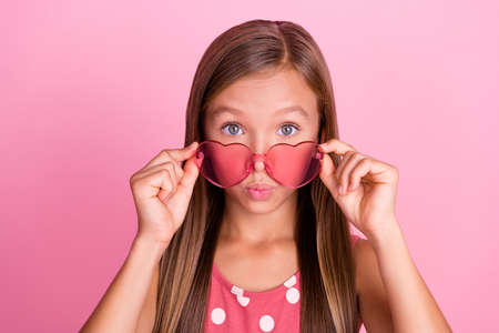 Photo of impressed little person hands touch glasses pouted lips isolated on pink color backgroundの写真素材