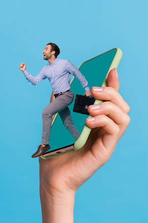 Vertical creative collage image of excited person jump running big telephone screen isolated on blue...