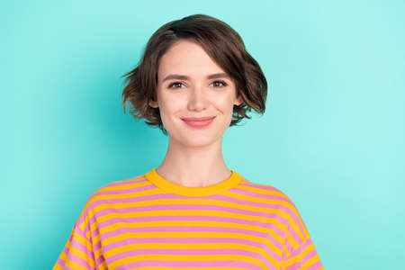 Portrait of attractive cheery content brown-haired girl wearing striped pullover isolated over bright teal turquoise color backgroundの写真素材