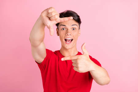 Photo of young guy happy positive smile show fingers frame border sign photographer isolated over...
