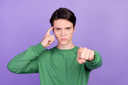 Photo of young guy finger touch head point finger you blame idiot stupid isolated over purple color...