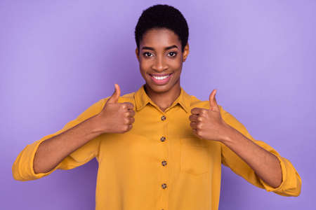 Portrait of attractive cheerful brunet girl showing double thumbup ad cool agree isolated over...