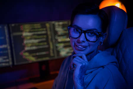 Photo of smart clever programmer wear hoodie piercing thinking new startup indoors workstation...