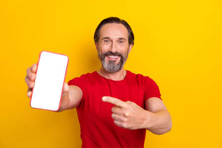 Photo of nice young brunet man index telephone wear red t-shirt isolated on yellow color background