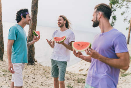 Photo of charming pretty young buddies dressed casual outfits talking eating tasty summer berry...