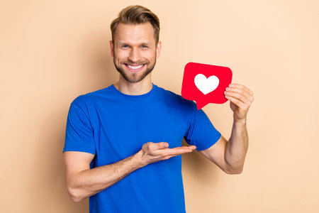 Photo of young guy promoter show app download button click select repost isolated over beige color...