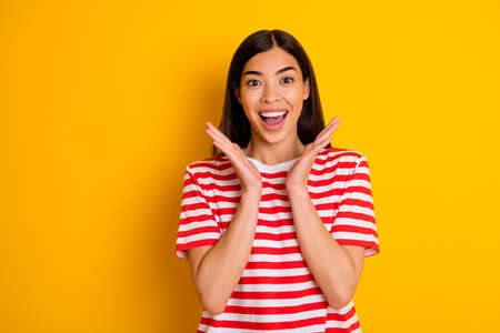 Portrait of astonished black hairdo lady raise opened hands wear red white isolated on yellow color...