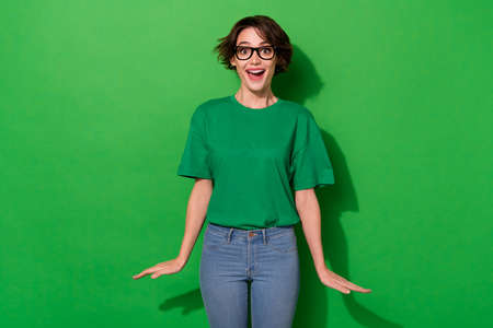 Photo of cheerful pretty impressed girl open mouth look camera isolated on green color backgroundの写真素材