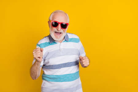 Portrait of attractive cheerful grey haired man fooling having fun dancing isolated over bright...