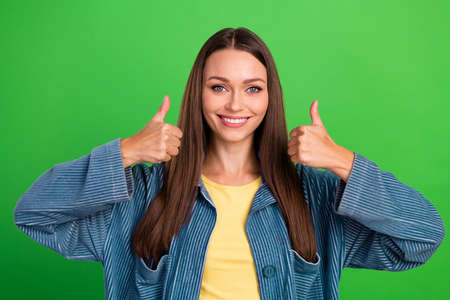 Portrait of nice satisfied person toothy smile hands fingers demonstrate thumb up isolated on green...