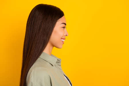 Profile side photo of adorable sweet young lady with long brunette hair look blank space isolated on...