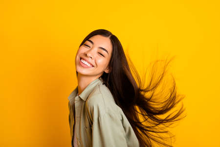 Profile portrait of gorgeous peaceful girl toothy smile have good mood isolated on yellow color...
