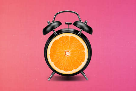 Collage artwork image of citrus fruit inside clock alarm healthy eating isolated pink bright color backgroundの写真素材