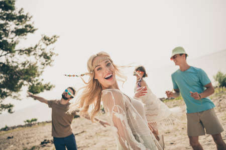 Photo of crazy hippie positive ladies have fun seaside season weekend best fellows dance sand outdoorsの写真素材