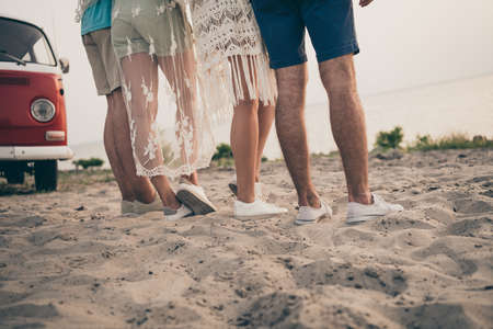 Photo of young company guy feet near the sea minivan holiday trip wear trend cloth outdoors outsideの写真素材