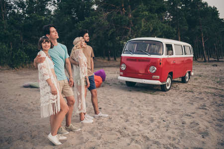 Photo of cheerful positive freinds embrace prepare leave camp wear boho outfit nature seaside beach...