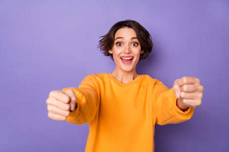 Portrait of attractive cheerful funny girl driving invisible car having fun isolated over violet lilac color backgroundの写真素材
