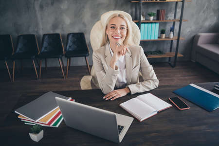 Photo of pretty positive lawyer lady sitting chair hold pen toothy smile modern office building insideの写真素材
