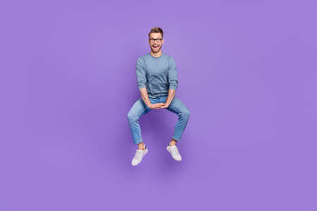Photo of sweet pretty guy dressed grey shirt glasses jumping high riding horse isolated purple color...