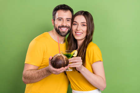 Photo of two funny cheerful people hold cocktail clink enjoy free time weekend chill isolated on...