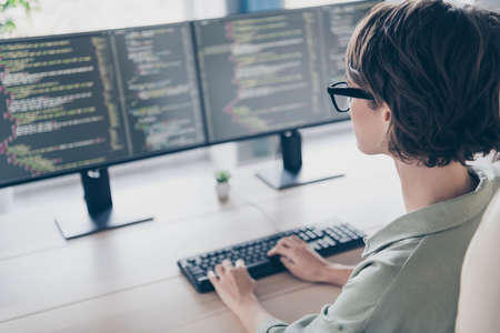 Back view photo of cool intelligent student girl system administrator practicing improving system...