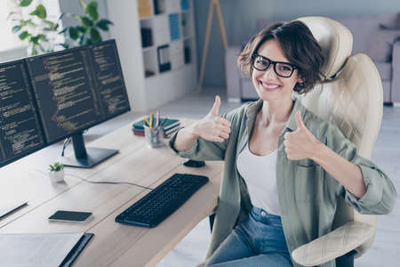 Photo of young experienced female love working web-designer demonstrate thumb-up recommend...