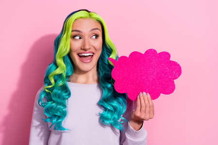 Photo of cute lovely girl look blank space dreaming have conversation with friend isolated on pink color backgroundの写真素材