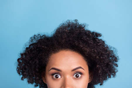 Cropped photo of young shocked amazed afro american woman with brunette chevelure isolated on blue color backgroundの写真素材