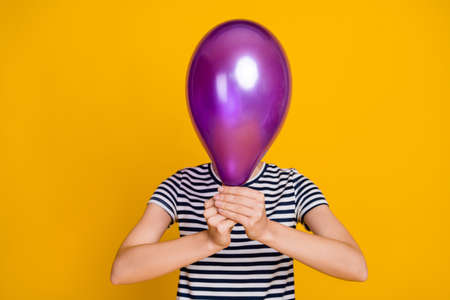 Photo of funky young lady hold balloon close face wear blue t-shirt isolated on yellow background