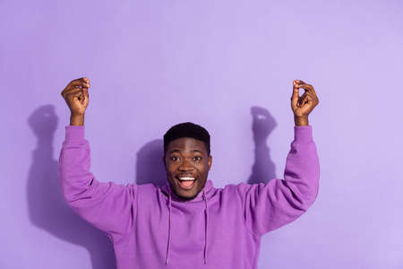 Portrait of attractive cheerful guy dancing having fun good mood rest isolated over bright violet lilac color backgroundの写真素材
