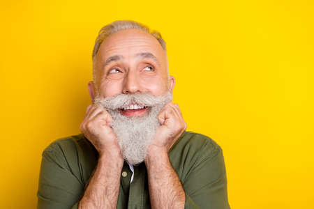 Photo portrait of senior man in green shirt smiling cheerfully looking dreamy empty space isolated...