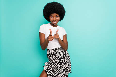Photo of cool short hairdo young lady point camera wear white t-shirt skirt isolated on cyan color backgroundの写真素材