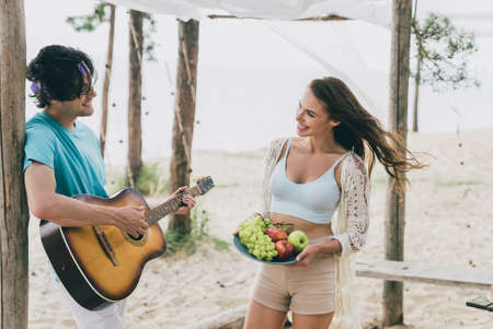 Photo of lovely cute couple spend their honeymoon at tropical island wife listening her husband...