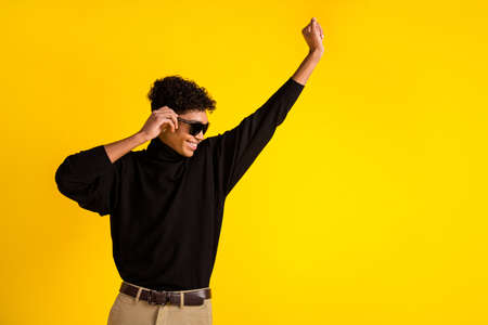 Profile photo of optimistic nice brunet guy dance wear spectacles black sweater isolated on yellow...