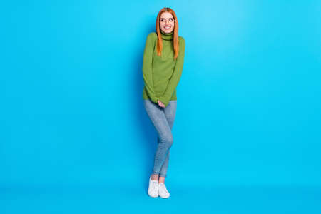 Full length body size view of attractive cheerful shy girl posing thinking copy space isolated over bright blue color backgroundの写真素材