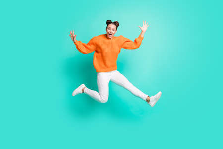 Full size photo of optimistic nice brunet lady jump wear sweater jeans isolated on teal backgroundの写真素材