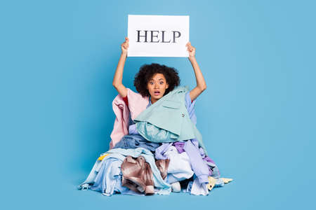 Photo of impressed stressed young lady covered large staff stack rising help card isolated blue...