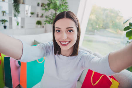 Portrait of cheerful positive person make selfie recording video toothy smile order delivery packages house indoorsの写真素材