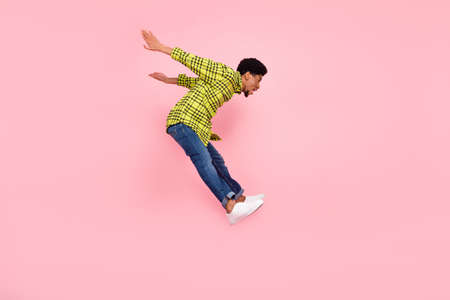 Full body photo of happy afro american man jump up empty space crazy mood isolated on pink color...
