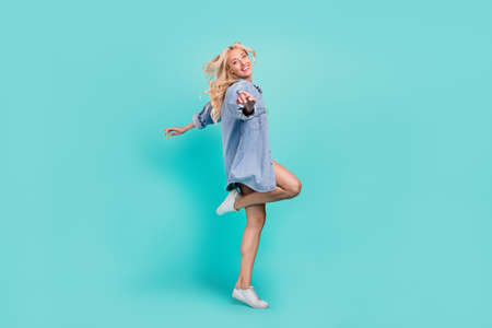 Full body photo of happy young charming woman fly hair wind blow summer cool isolated on blue color...