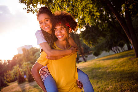 Portrait of attractive adorable affectionate cheerful couple life partners guy piggybacking girl...