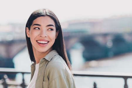 Photo of adorable excited lady dressed casual clothes smiling enjoying sunshine walking outside...