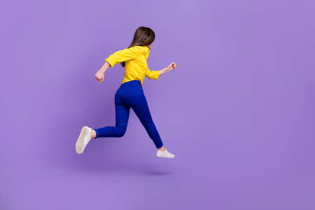 Full length body size view of attractive energetic girl jumping running fast isolated over bright...