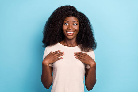 Photo of crazy astonished person hands touch chest cant believe isolated on blue color backgroundの写真素材