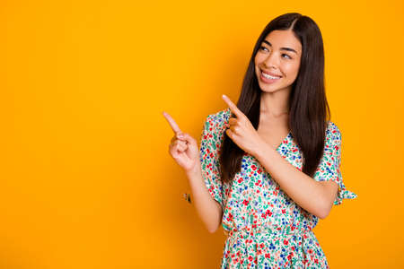 Photo of gorgeous elegant lady look blank space promote advertise product object isolated on yellow color backgroundの写真素材