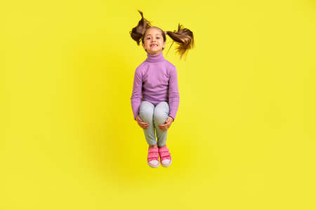 Full size photo of lovely pretty kid girl jumping high isolated vivid bright color backgroundの写真素材