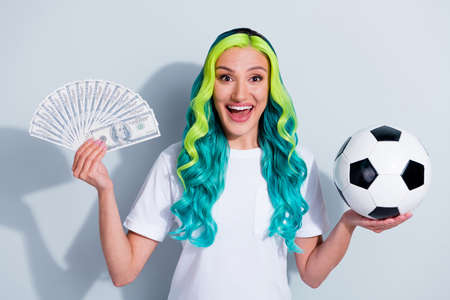 Photo of pretty excited vivid ombre hair lady wear t-shirt holding ball cash fan isolated white...