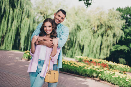 Photo of two idyllic peaceful partners cuddle hugging toothy smile spend free time walk outdoorsの写真素材