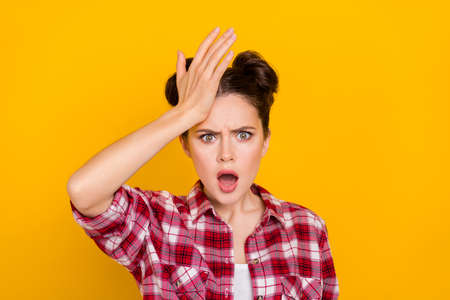 Portrait of unsatisfied lady hand touch forehead open mouth isolated on yellow color backgroundの写真素材